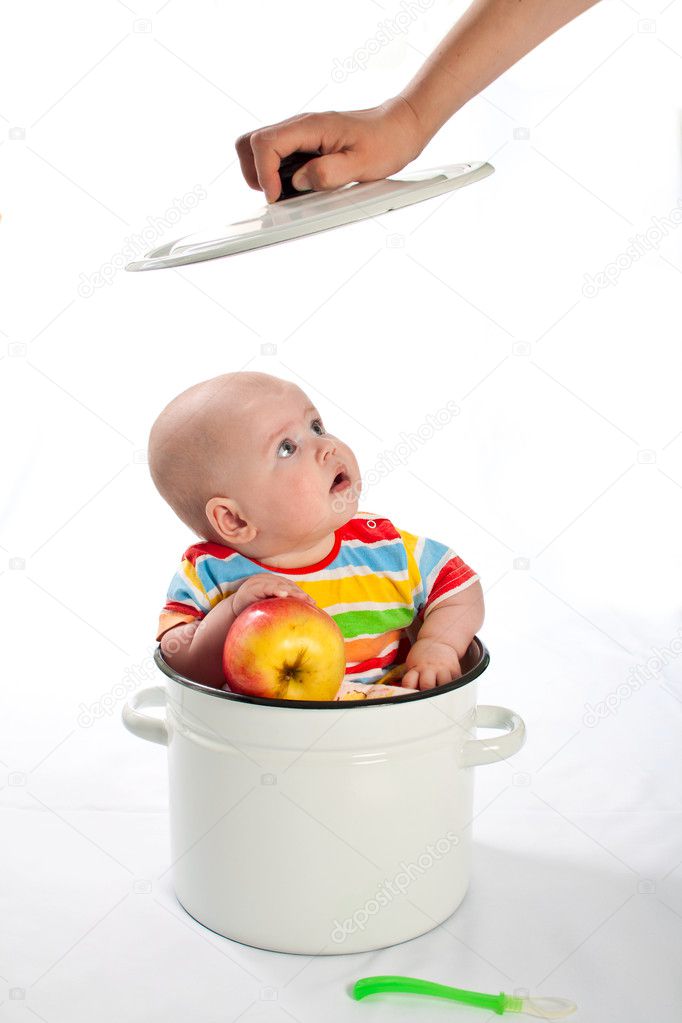 Baby sitting in the big saucepan.