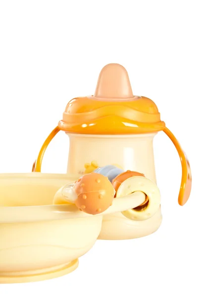 Children plate and plastic baby bottle. — Stock Photo, Image
