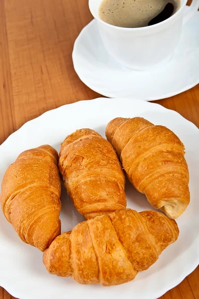 stock image Newly-baked croissants and cup of coffee.