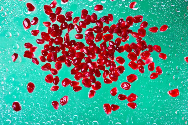 Pomegranates on green background — Stock Photo, Image