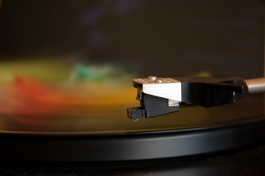 70's model turntable playing colourful music clipart