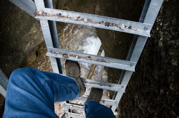 Climbing the ladder over the abyss — Stock Photo, Image