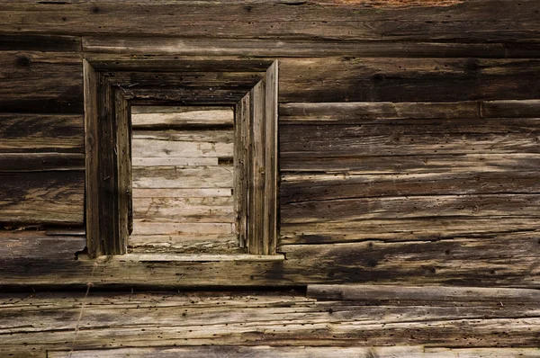Window of damaged wooden lodge — Stock Photo, Image