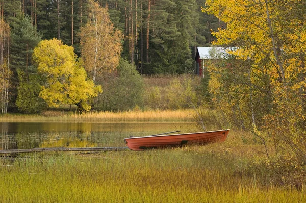 Autumn scenery with cabin and boat — Stock Photo, Image