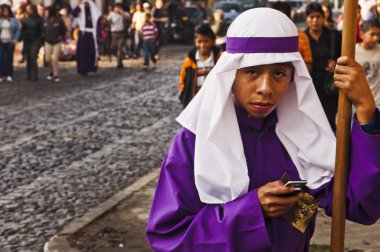 Purple robed boy on cell phone clipart