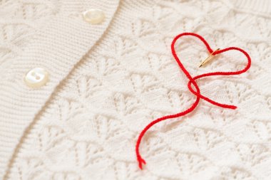 Red heart on a white blouse clipart