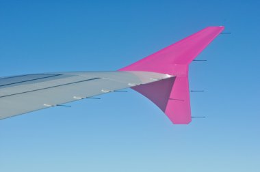 Aircraft wing on a blue sky clipart