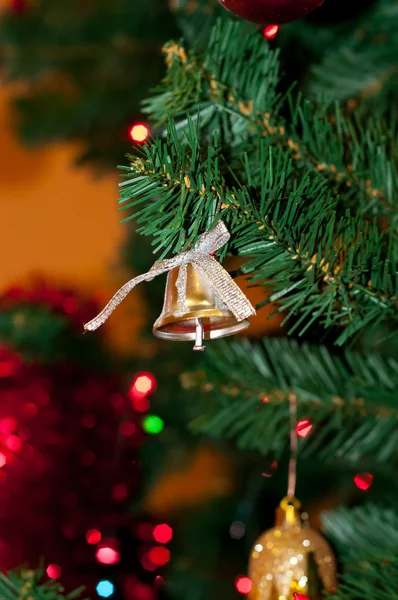 Bell decoration in a Christmas tree. — Stock Photo, Image