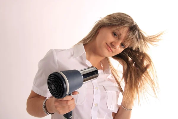 stock image Young girl with hair dryer