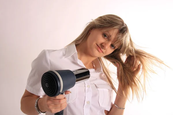 Young girl with hair dryer Stock Image