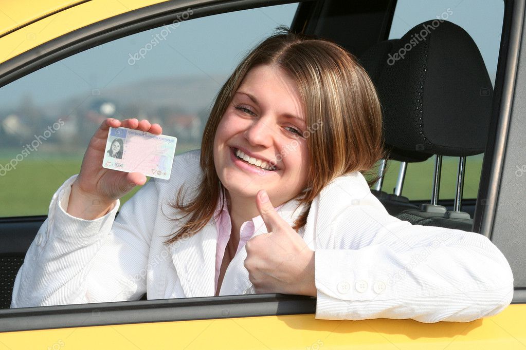 Young woman showing her driver license
