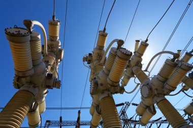 Electric substation in a bright sunny day with the blue sky clipart