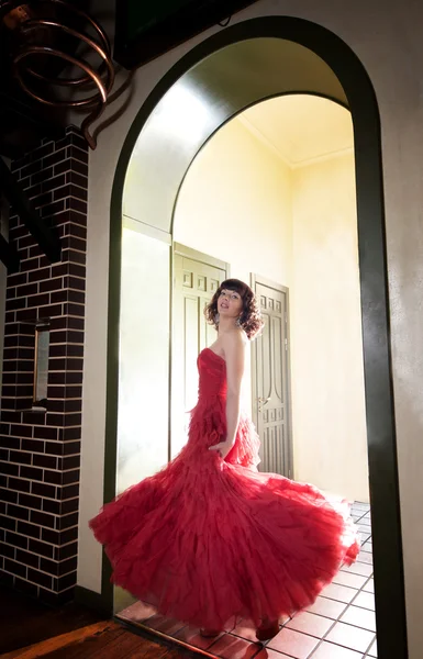 Woman in red at the door — Stock Photo, Image