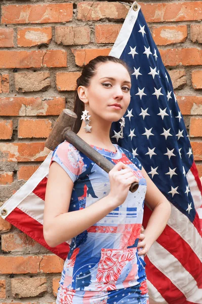 Girl with USA flag and a hammer — Stock Photo, Image
