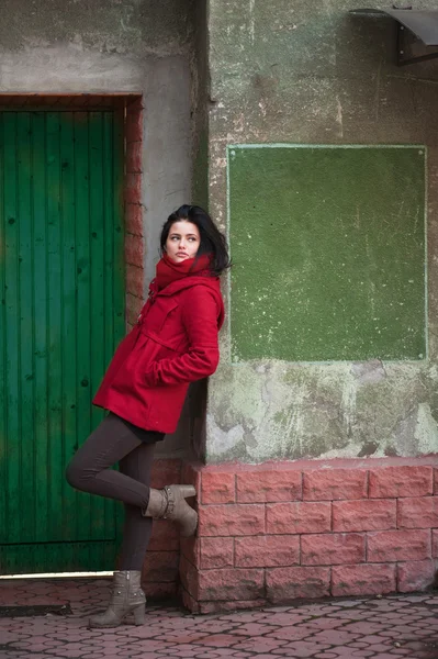 stock image Young girl at the green door