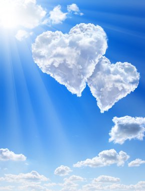 Hearts in clouds against a blue clean sky clipart