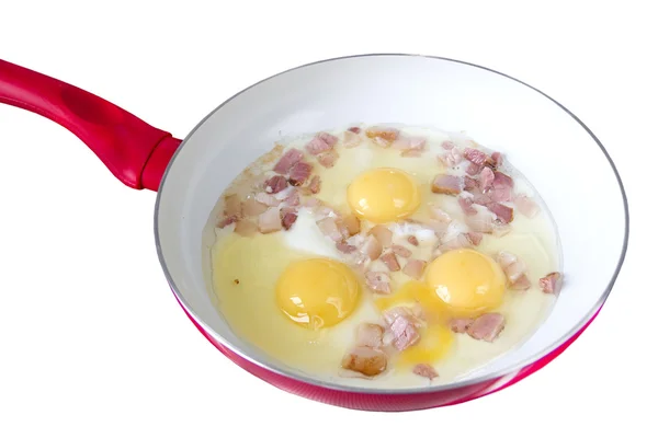 Scrambled eggs with bacon in a frying pan — Stock Photo, Image
