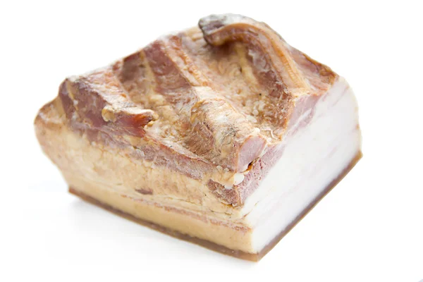 Um pedaço de bacon defumado — Fotografia de Stock
