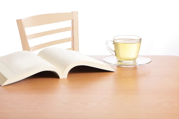 Tea and book on wood table — Stock Photo, Image