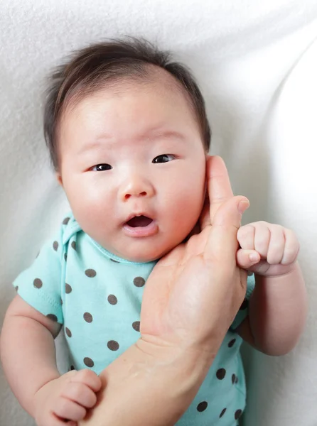 Mamma hand rör baby leende ansikte — Stockfoto