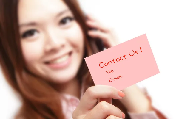 Smiling business woman holding a card (Contact Us) and speaking — Stock Photo, Image