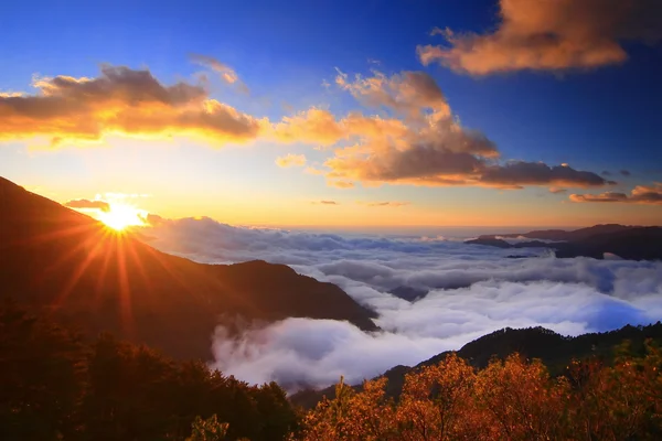 stock image Amazing sunrise and sea of cloud with mountains