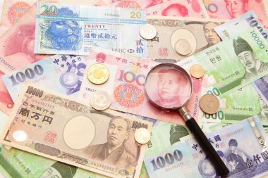 Asian currency, magnifying glass and Background of asian currency clipart