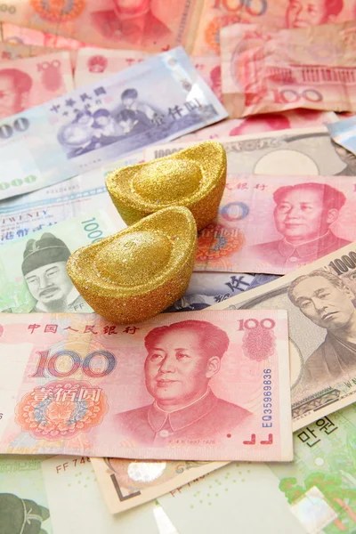 Złote monety i tło azjatycki waluty — Zdjęcie stockowe
