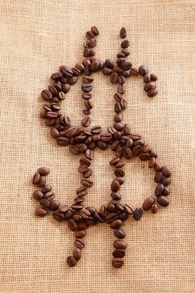 Kávové fazole na pozadí plátna (peněžní symbol ) — Stock fotografie