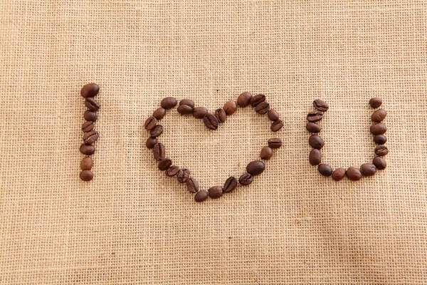 Granos de café sobre fondo de lino (I Love You TEXT ) —  Fotos de Stock