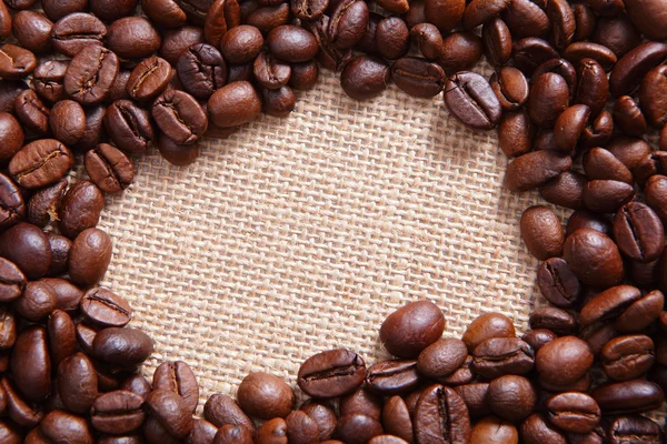 Grãos de café em fundo de linho — Fotografia de Stock