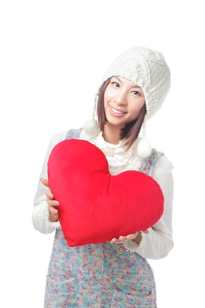 Young girl hold a love heart pillow — Stock Photo, Image