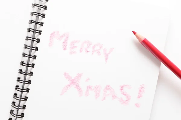 Cuaderno (escribe Feliz Navidad) y lápiz rojo —  Fotos de Stock