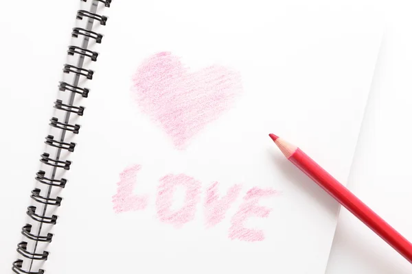 Ноутбук (писать любовь) и красный карандаш — стоковое фото
