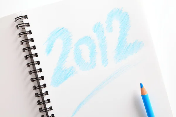 Notatnik (writed 2012) i niebieski ołówek — Zdjęcie stockowe