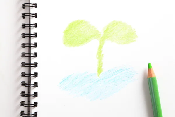 Caderno (com broto verde) e lápis verde — Fotografia de Stock