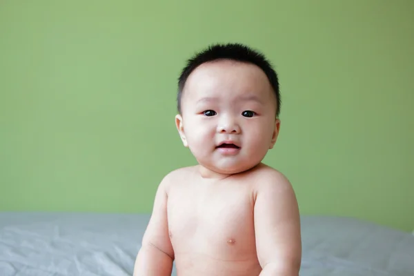 Portrait of smiling baby with green background — Stock Photo, Image