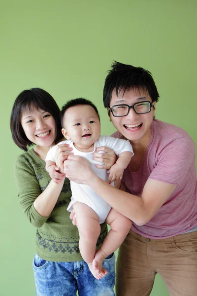 stock image Family (Mother, father and small baby) smile face with green bac