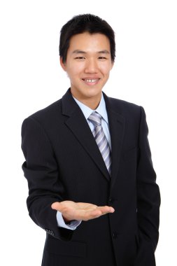 Young business man holding hand presenting a product clipart