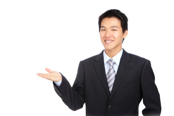 Joven hombre de negocios sonrisa y mostrando introducir gesto de la mano — Foto de Stock