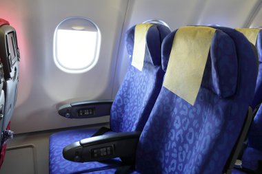 Airplane blue seat and window inside an aircraft clipart