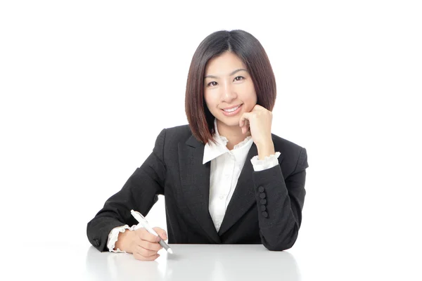 Portrait of Business woman sitting on desk with pen — Stock Photo, Image