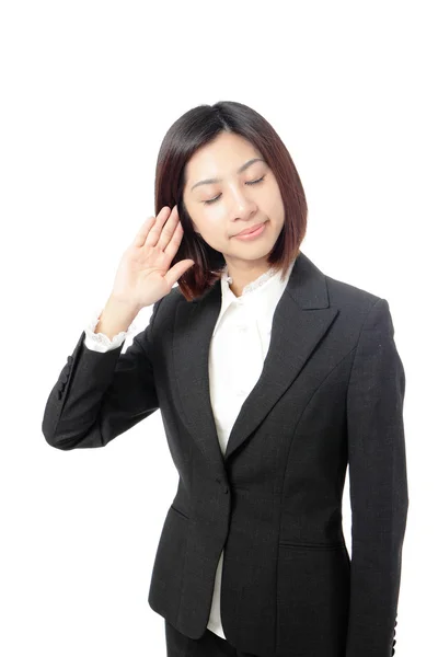 Mulher de negócios com mão para orelha ouvindo — Fotografia de Stock