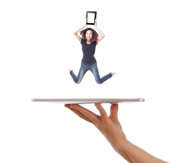 Young girl jump showing tablet pc on hand — Stock Photo, Image