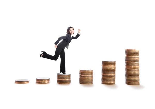 Young business woman running on money stairs — Stock Photo, Image