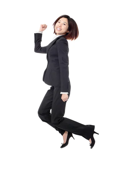 Successful businesswoman in suit jumping joyful — Stock Photo, Image