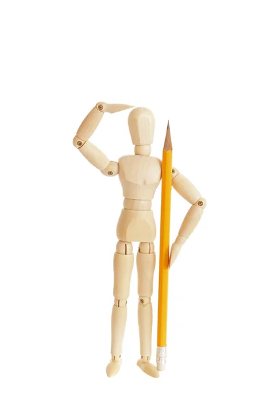 Bonito figura de madeira segurando lápis e olhando — Fotografia de Stock
