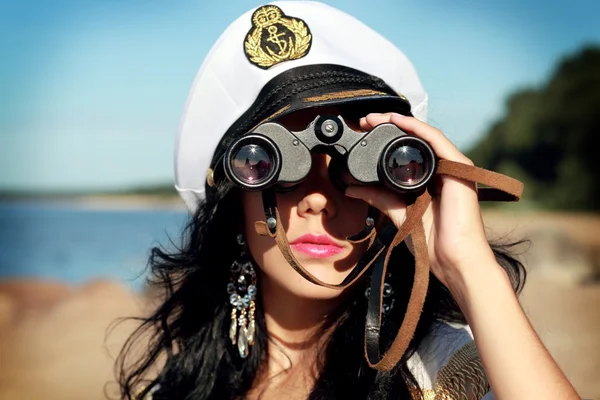 stock image Sailor female with binoculars is taking a walk on the seacoast