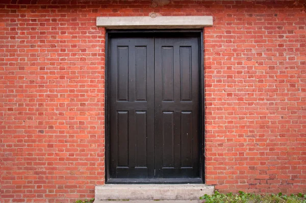 Black Door on Brick Exterior