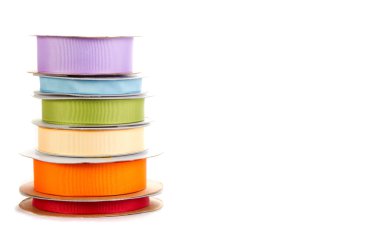 Spools of ribbon on white clipart